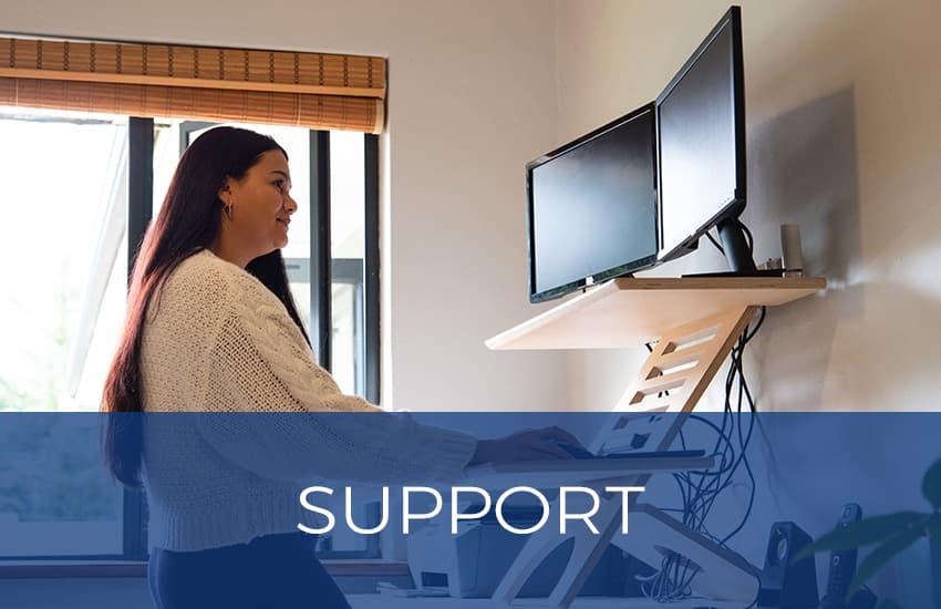 woman at a standing desk working